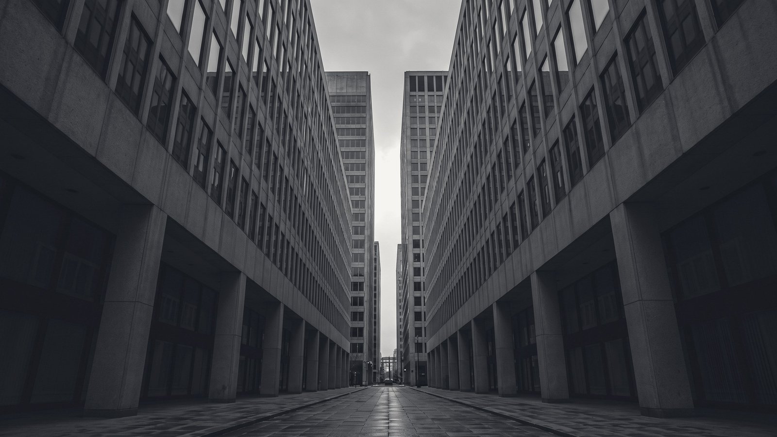 A narrow corridor of concrete towers receding into haze.