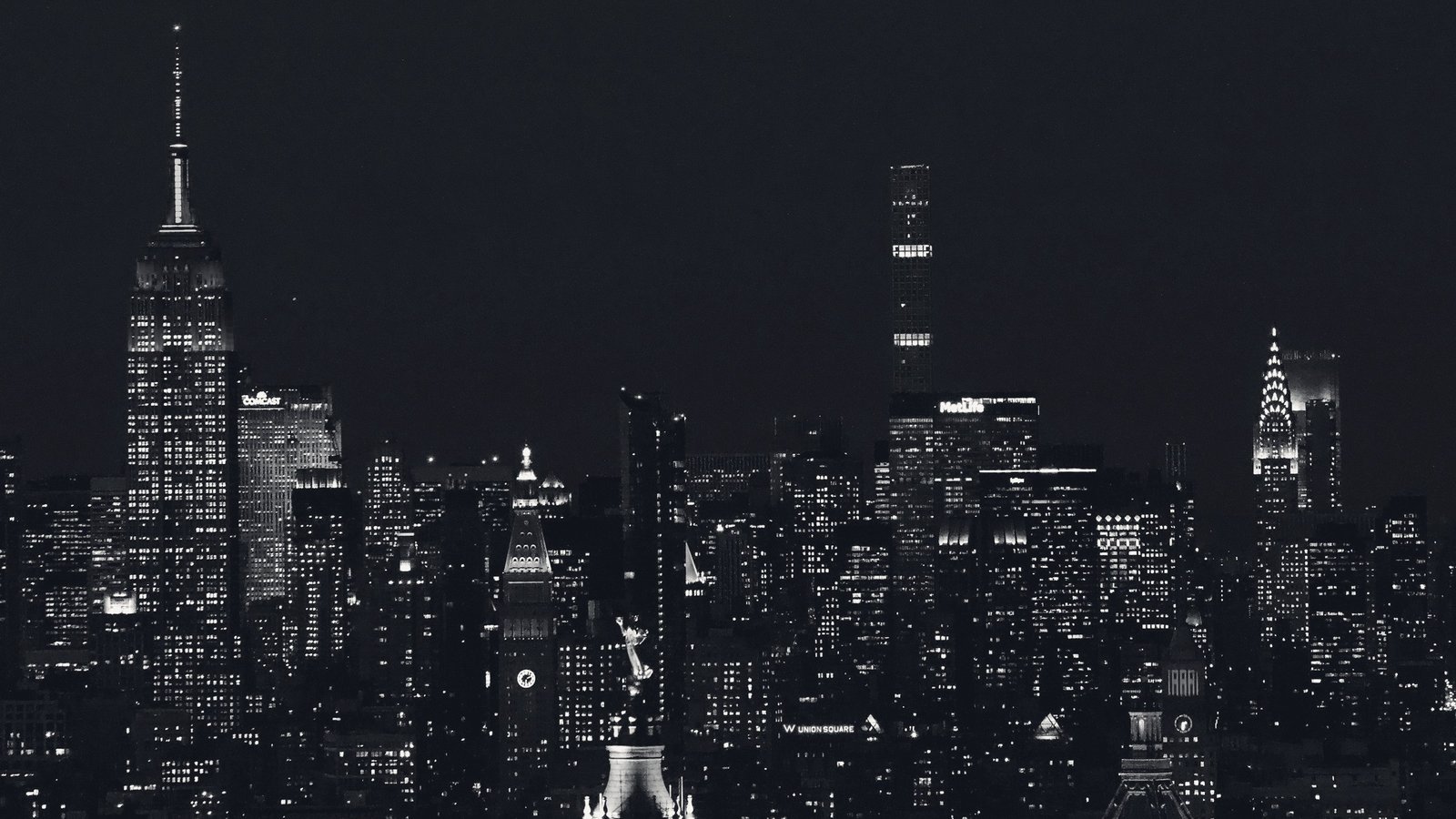 The Manhattan skyline at night in monochrome.